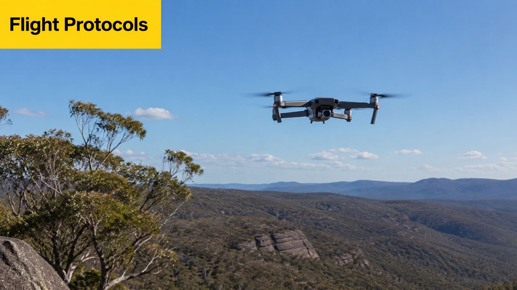 A drone flying over a vast, hilly Australian landscape during the day with clear blue skies.